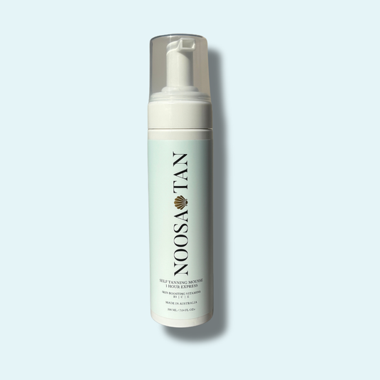 Foam bottle labeled 'NOOSA TAN' on a light blue background