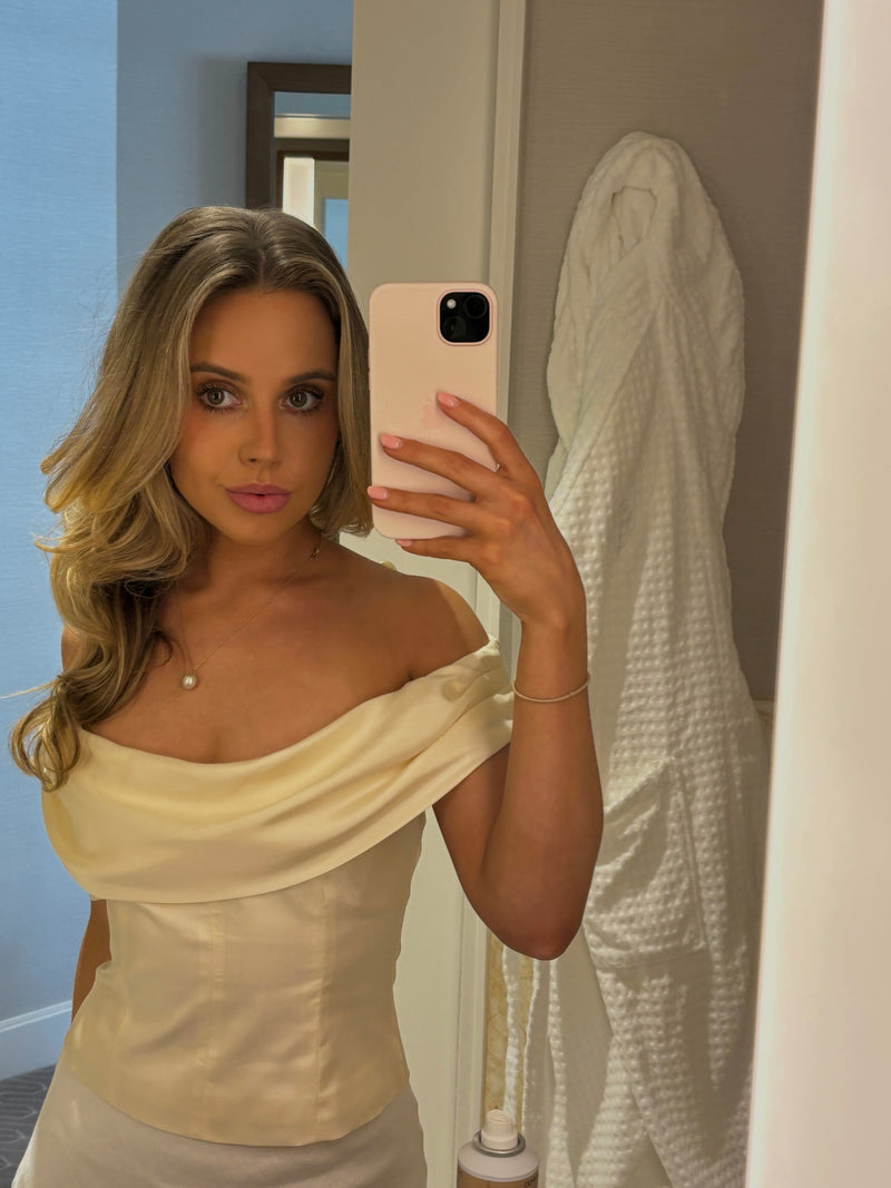 Girl taking mirror selfie whilst looking tanned